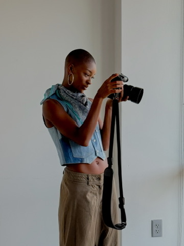 Model reviewing frames on a camera between looks